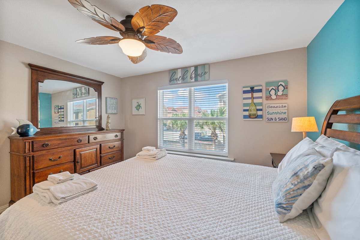 Drift off in your tropical-themed bedroom with coastal décor, tropical ceiling fan, and fresh towels waiting for you.