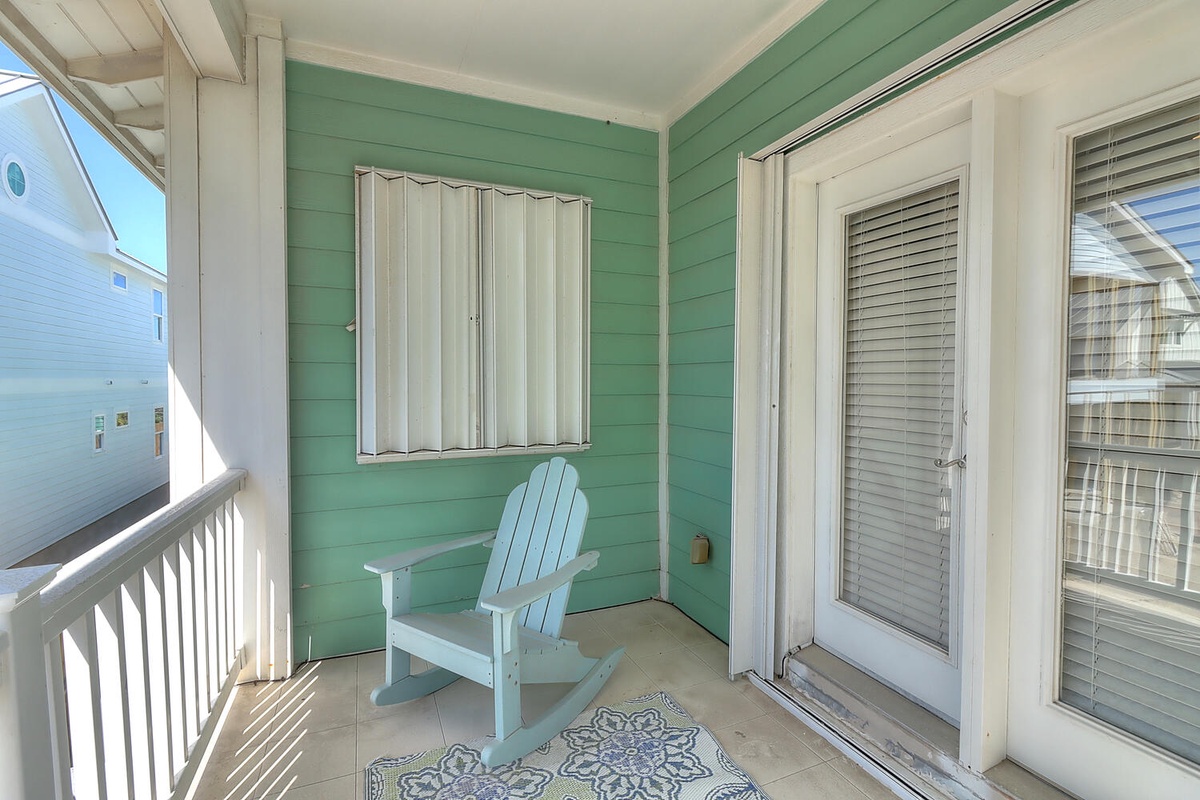 Your private balcony beckons with a cozy rocking chair where you can sip morning coffee and watch the coastal world wake up.