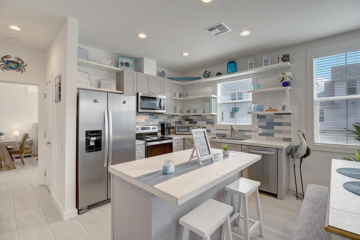 Create culinary memories in your fully-equipped kitchen featuring modern appliances, ample counter space, and charming coastal touches throughout.
