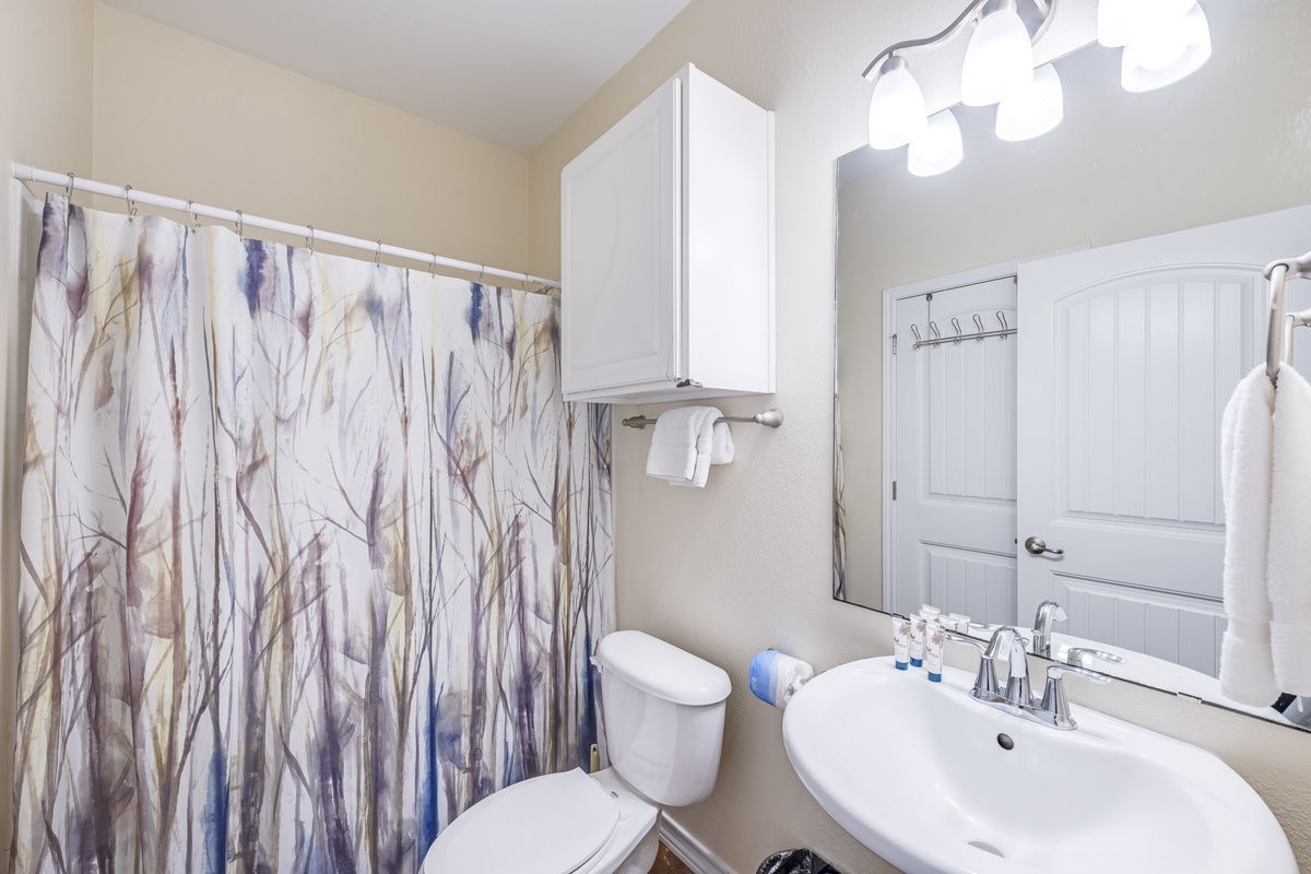 Your serene bathroom features soft lighting and elegant finishes, perfect for unwinding after your adventures.