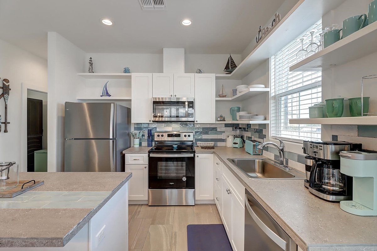 Your bright, fully-equipped kitchen features everything you need for memorable meals, from coastal-themed touches to modern appliances.