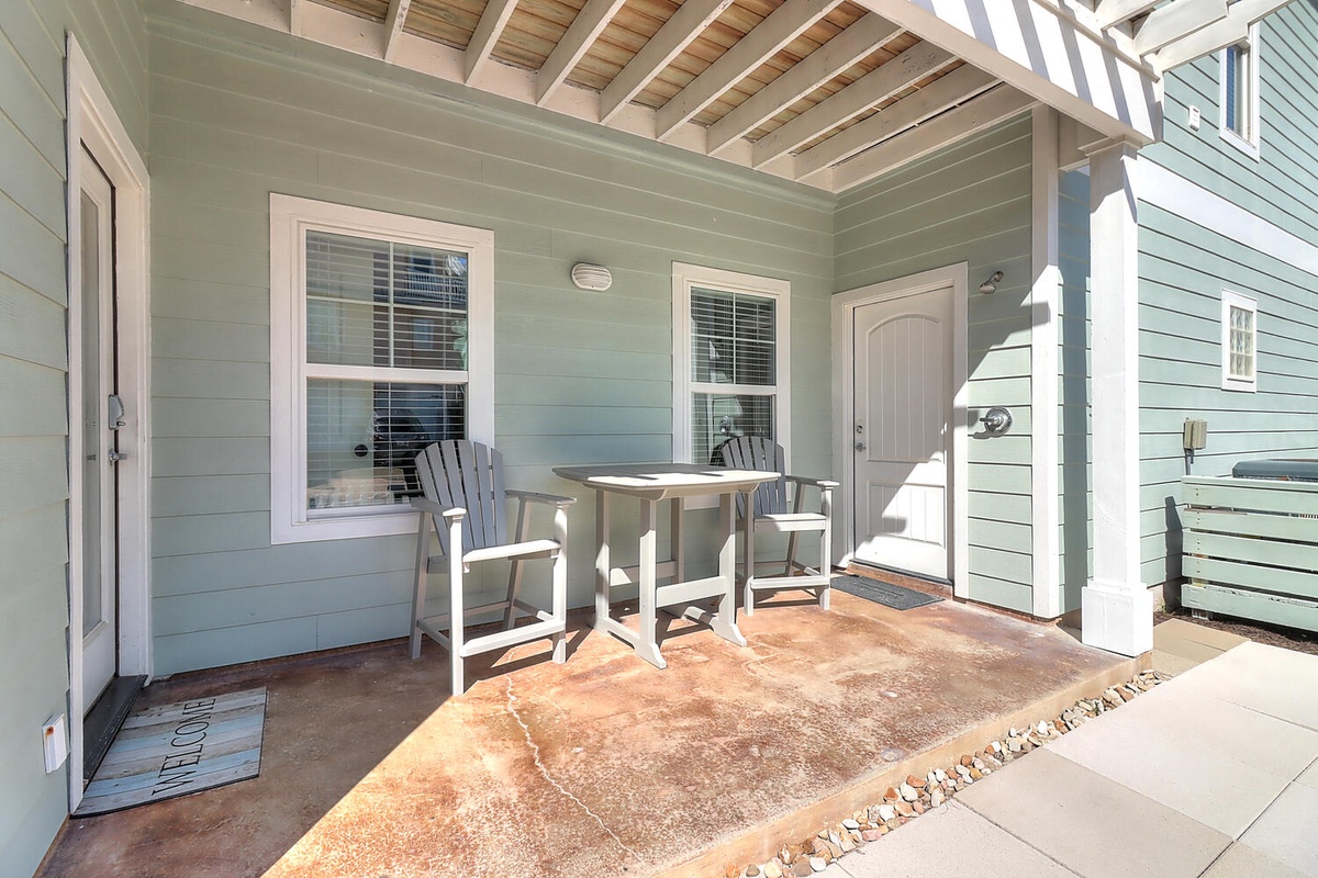 Relax on your private covered patio with comfortable seating and charming coastal touches, perfect for morning coffee or evening conversations.