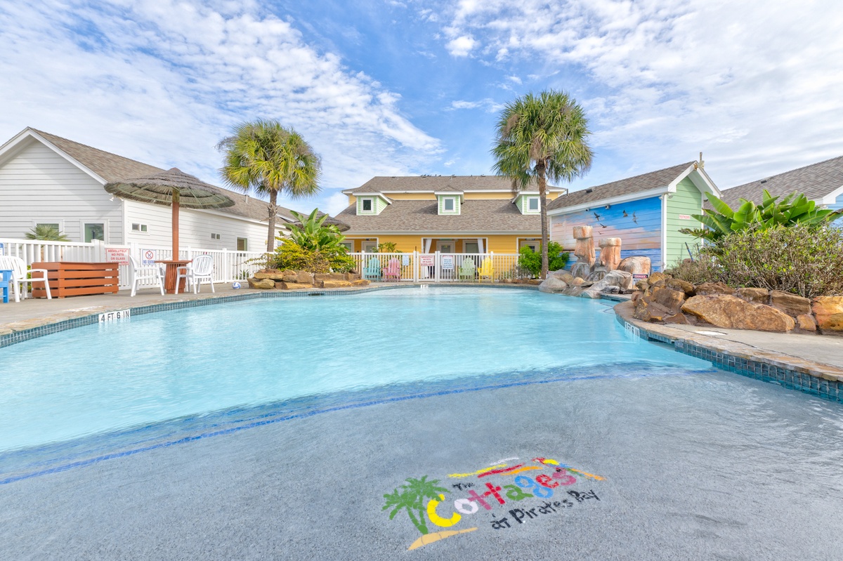 Dive into your tropical paradise with a stunning pool surrounded by colorful beach houses and swaying palms.