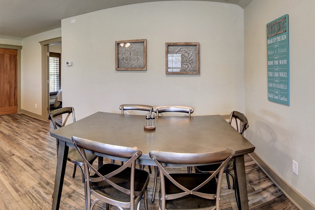 Gather around your spacious dining table where coastal charm meets comfort, perfect for sharing meals and making memories together.