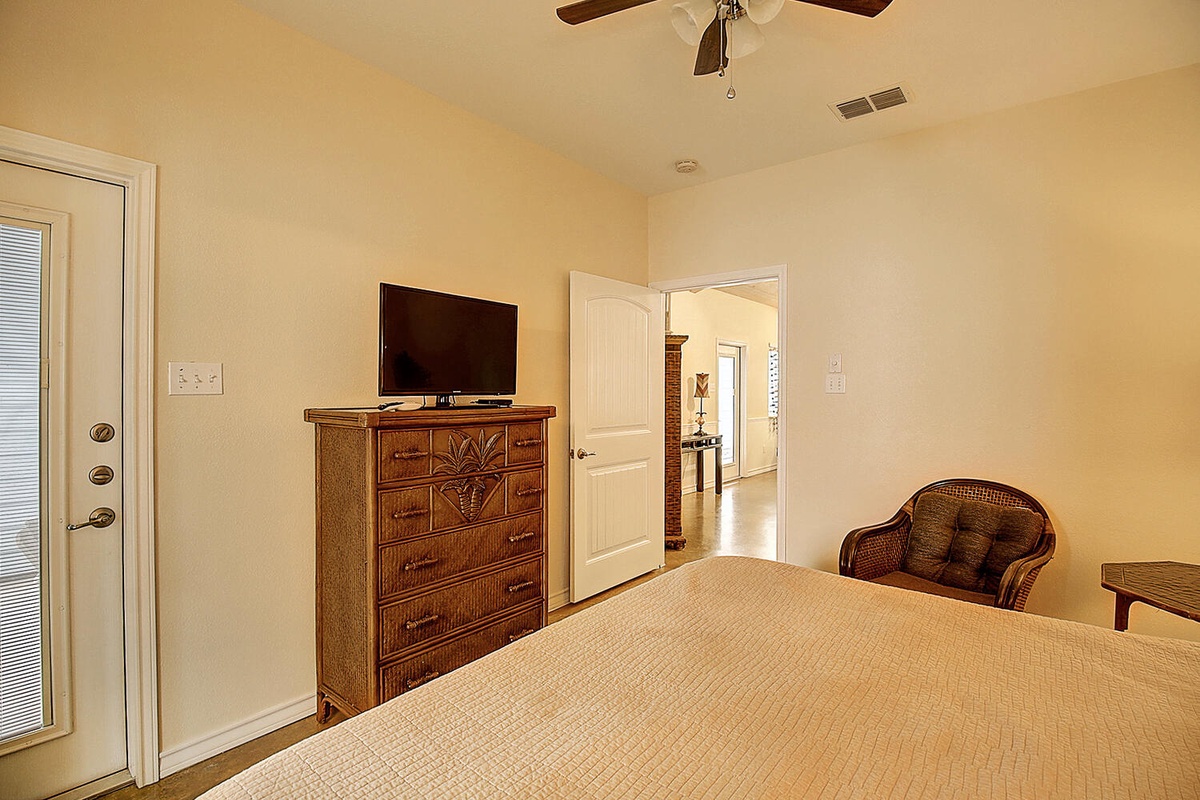 Your cozy bedroom features warm wood furnishings, ceiling fan comfort, and a peaceful atmosphere for restful nights.