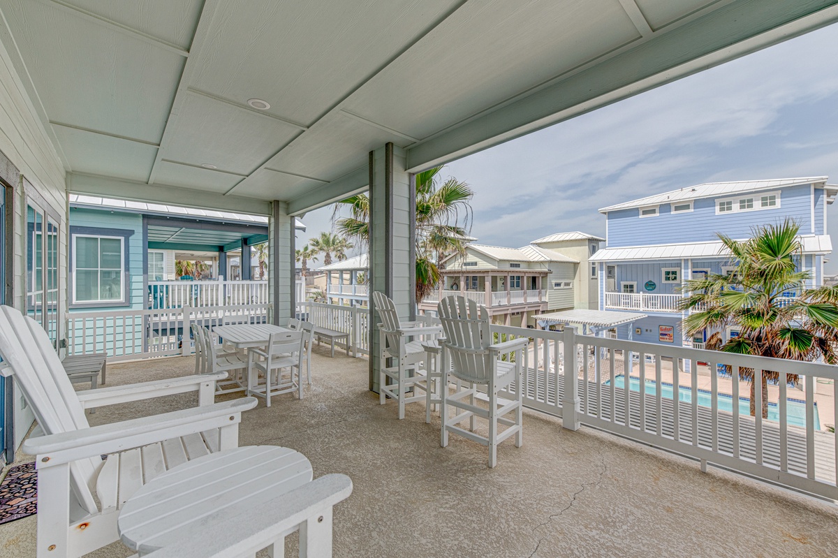 Your private balcony features comfortable seating where you'll sip morning coffee and watch palm trees sway against the coastal sky.