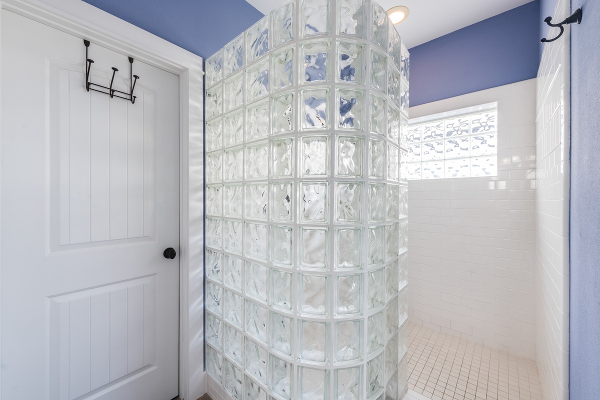 Step into your unique glass block shower—a stunning curved design that creates beautiful light patterns while you refresh.