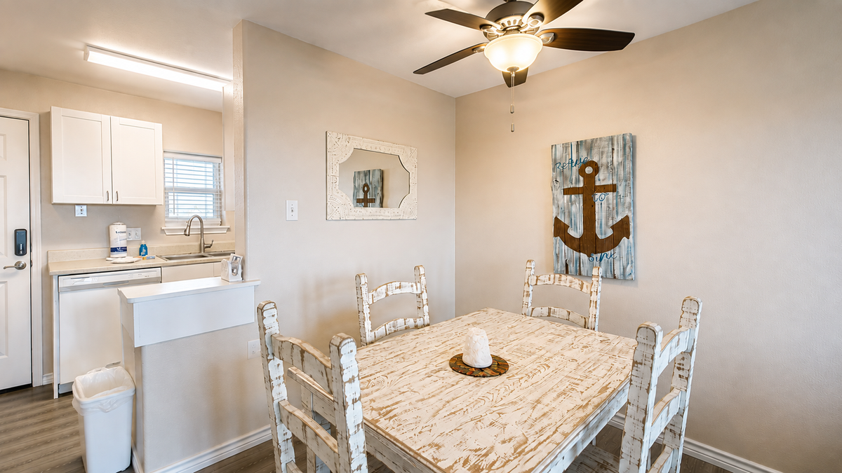 Your charming dining area features rustic furniture and coastal touches, creating the perfect spot for memorable meals together.