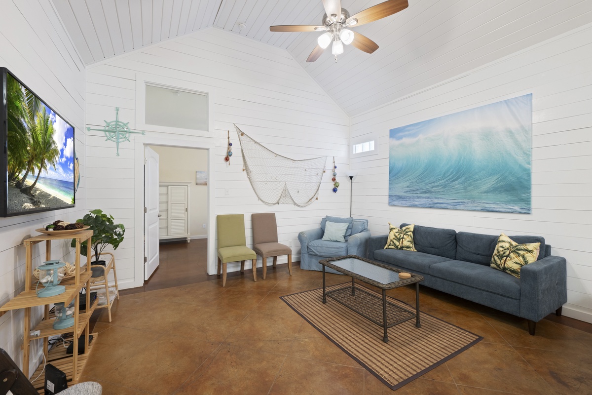 Unwind in your light-filled living room with coastal charm, vaulted ceilings, and comfy seating perfect for relaxing after beach days.