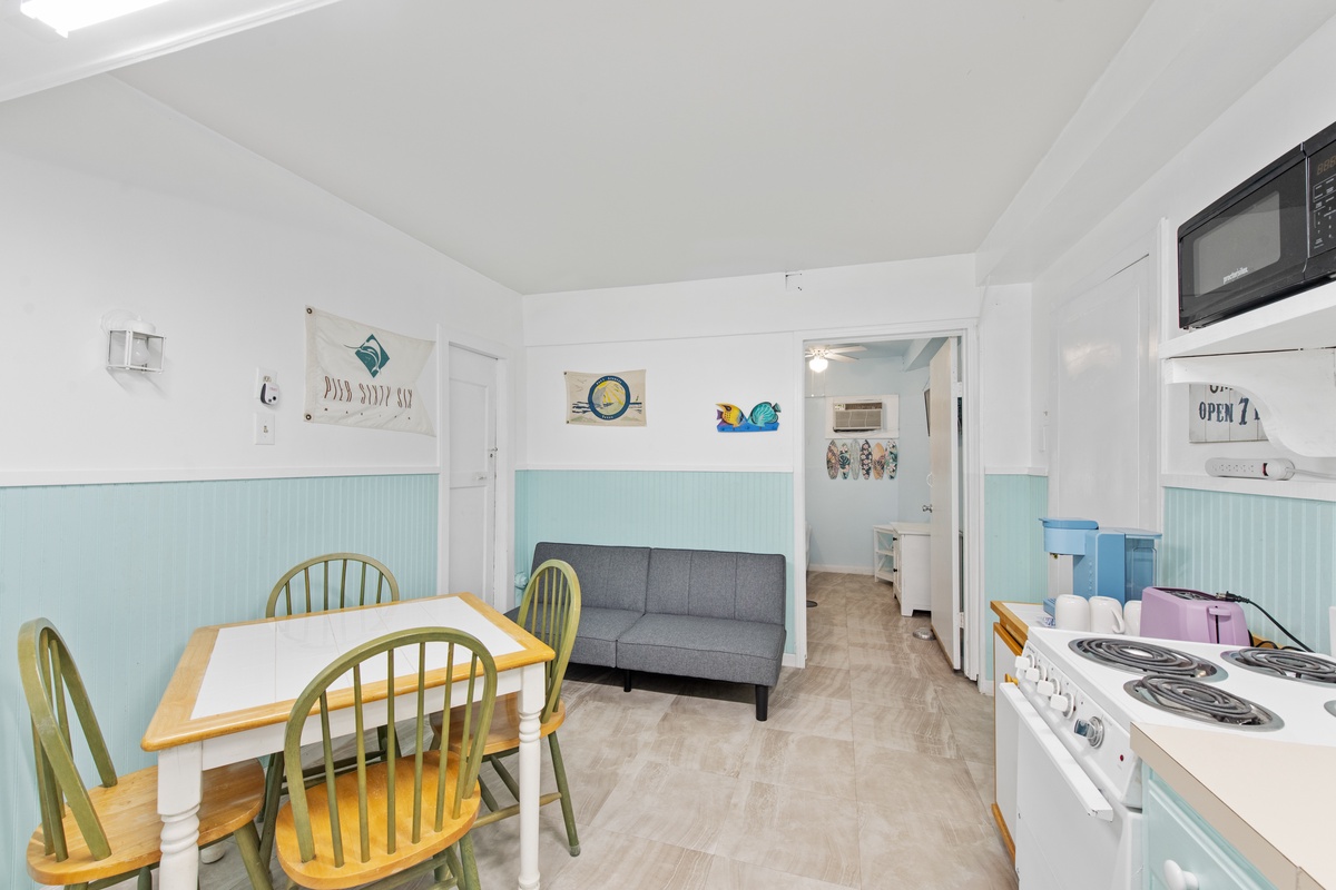 Unwind in your bright, coastal-inspired living space with a full kitchen, cozy dining nook, and comfortable seating area.