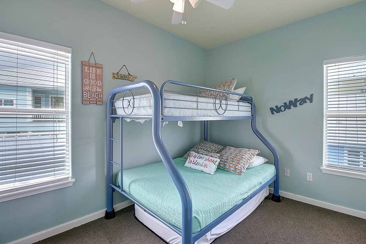Your family will love this cheerful beach-themed bunk room with twin-over-full beds and sunny coastal vibes.