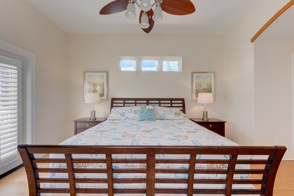 Sink into coastal comfort in your serene bedroom, where soft linens and gentle ceiling fan breezes ensure peaceful sleep.