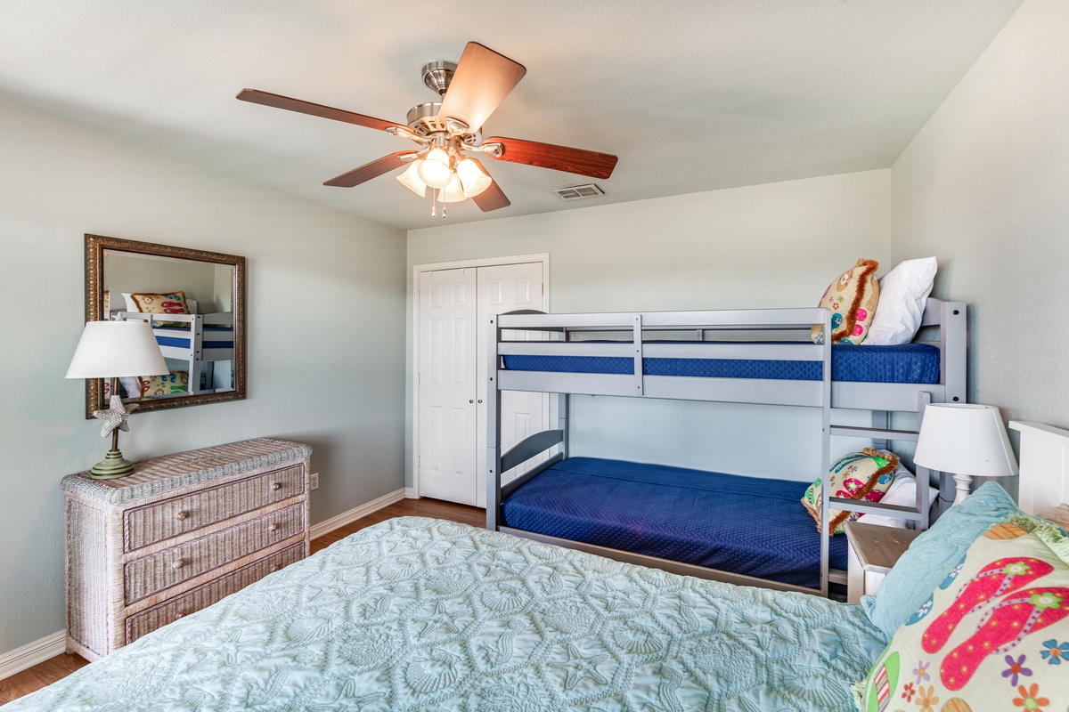 Rest comfortably with family in this cheerful bedroom featuring a cozy queen bed and fun bunk beds for the kids.