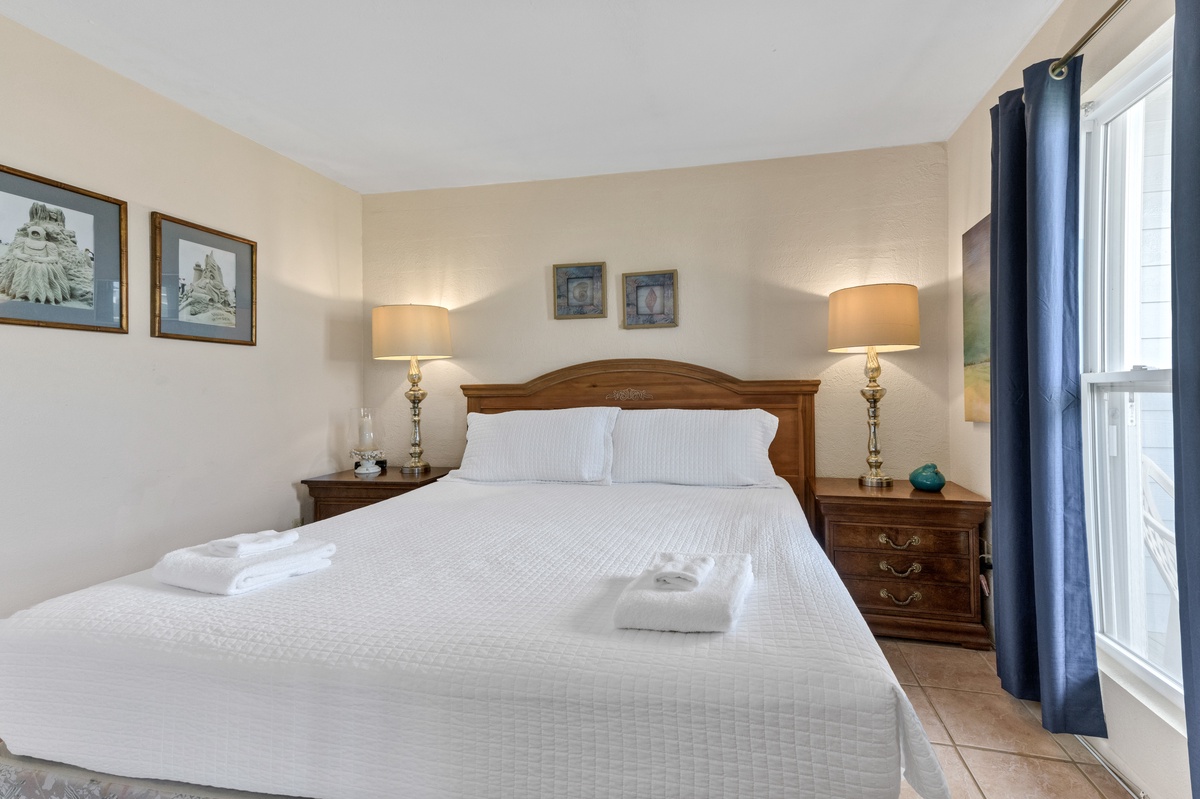 Sink into this inviting bedroom where crisp linens and warm lighting create your perfect retreat for restful nights.
