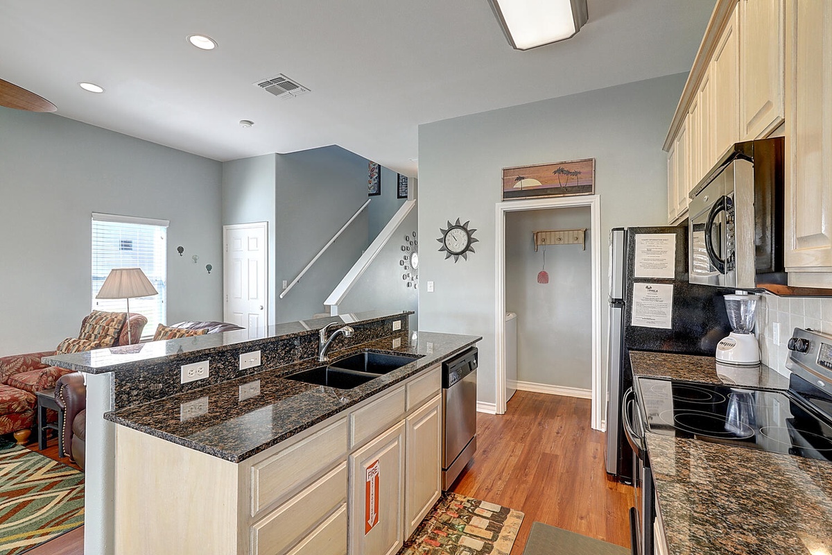 Your spacious kitchen features granite countertops and modern appliances, seamlessly flowing into the cozy living area for memorable meals together.