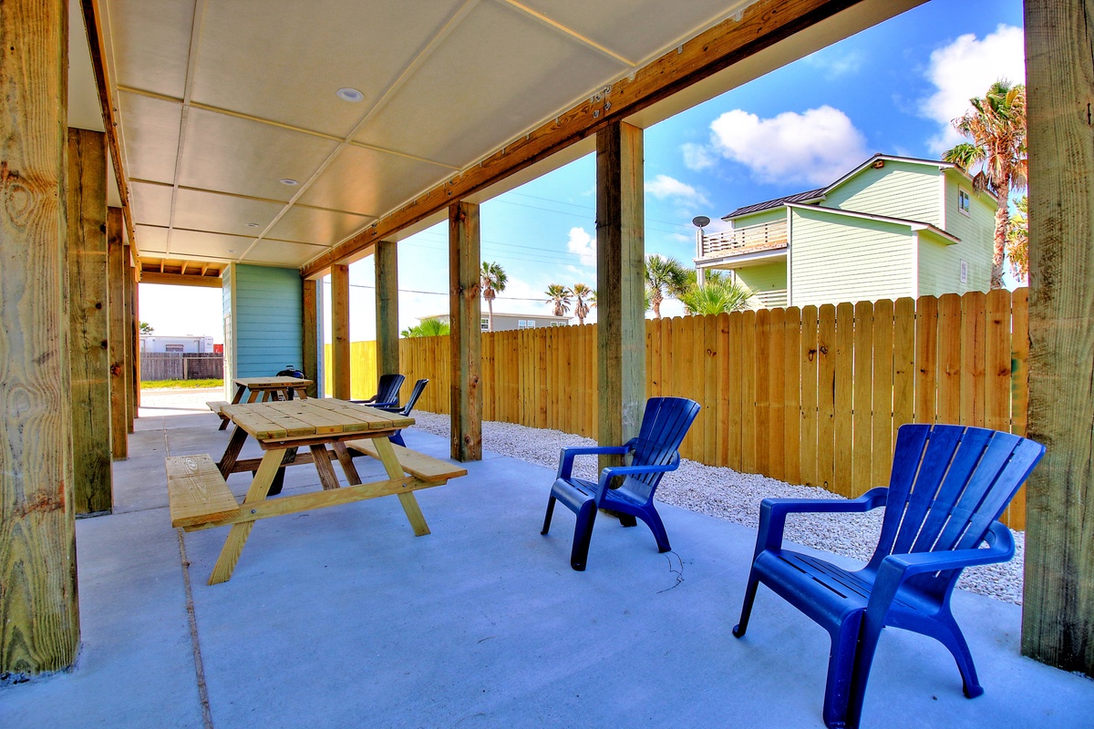 Your private covered patio offers the perfect spot to unwind with morning coffee or evening cocktails in these vibrant blue chairs.