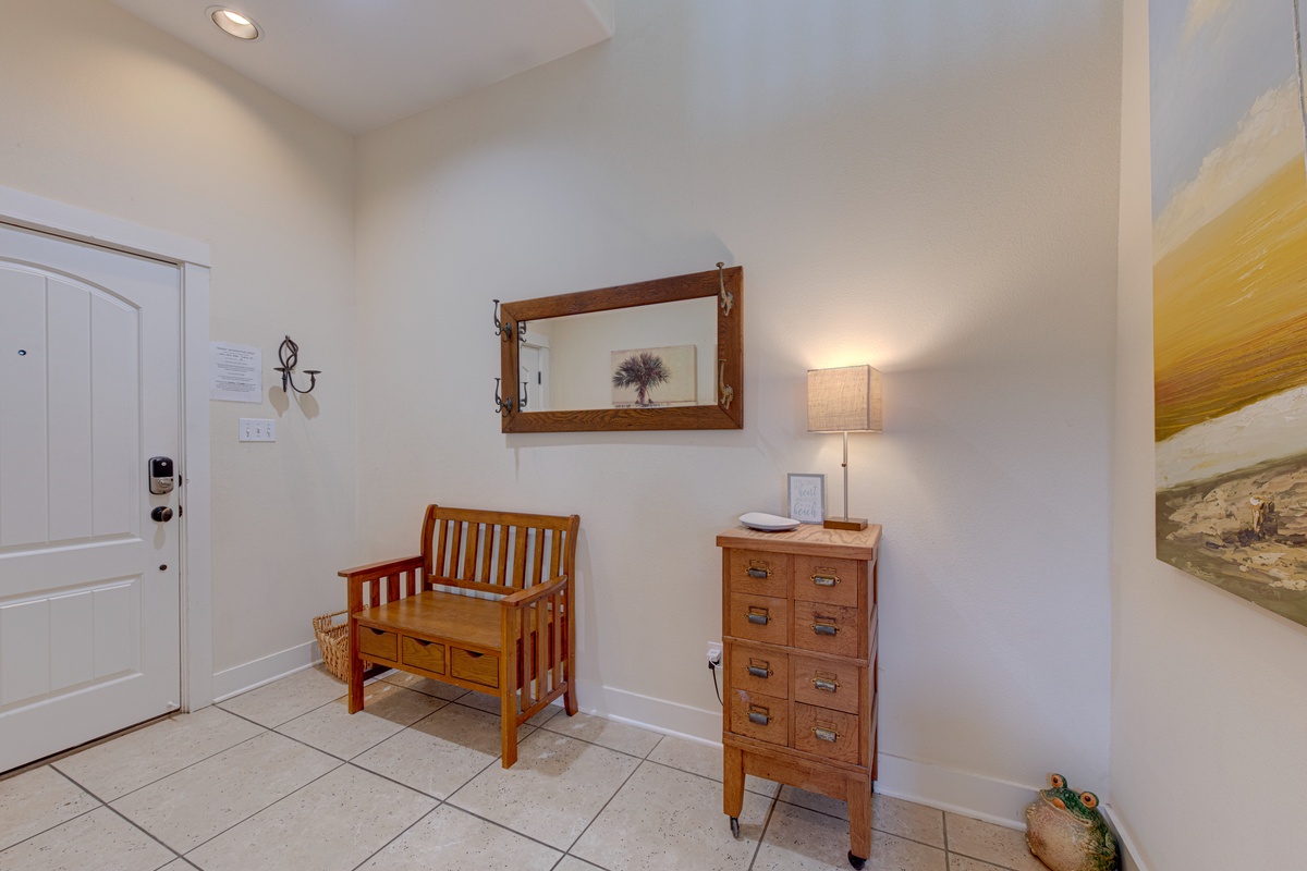 Step into your welcoming entryway, where warm wood furnishings and soft lighting create an instantly calming atmosphere after your travels.