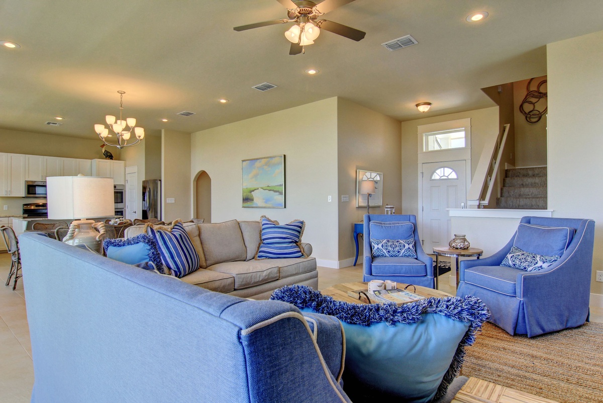 Unwind in this gorgeous open-concept space where soft blues and creams create your perfect coastal retreat atmosphere.