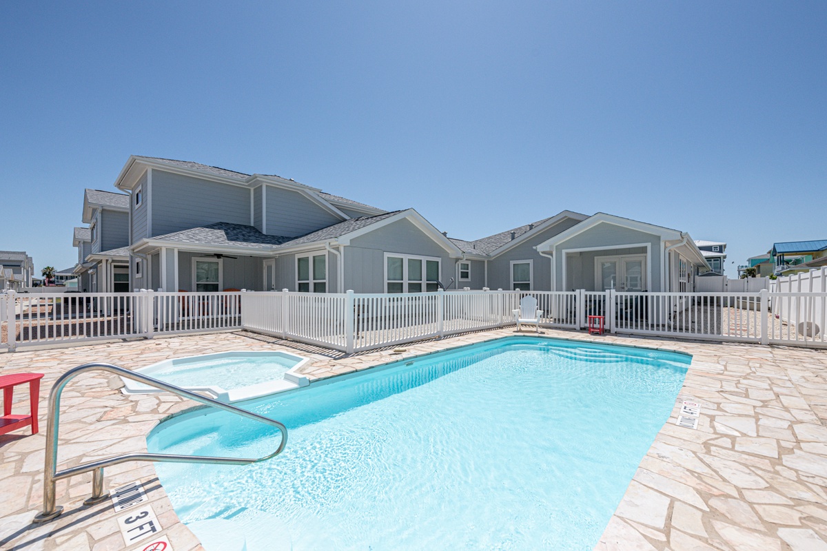 Dive into your private pool paradise, where crystal-clear waters await beneath endless blue skies.