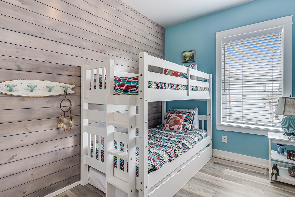 Your kids will love this cheerful bunk room with its coastal-themed decor and cozy sleeping space for memorable family adventures.