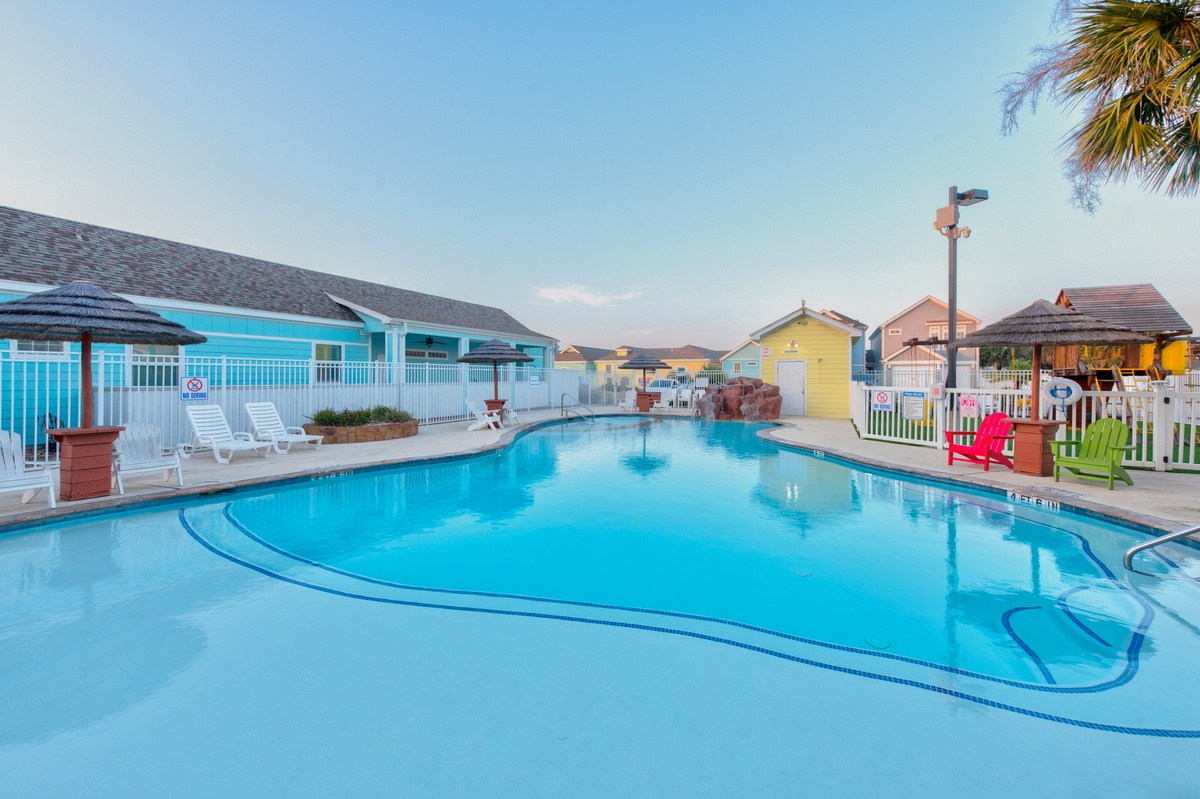 Dive into crystal-clear waters surrounded by vibrant tropical charm and colorful beach cottages for your perfect getaway.