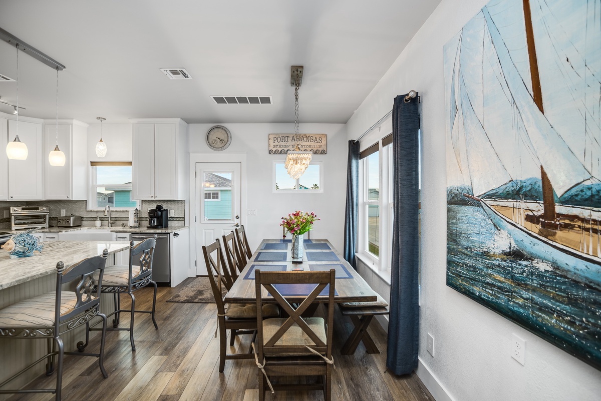 Relax in your coastal-inspired kitchen and dining space, where nautical artwork and modern comfort create the perfect seaside retreat.