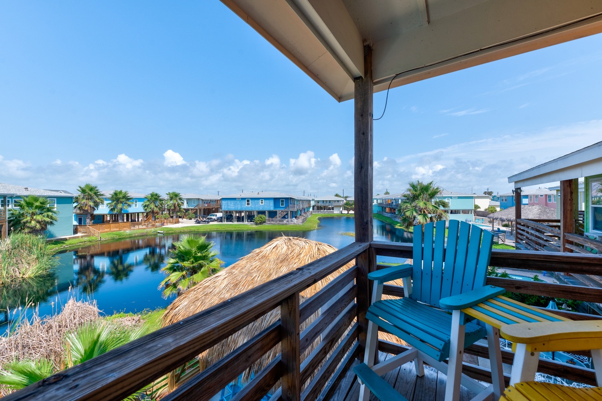 Waterfront community views with colorful beach houses and canal access create a peaceful coastal getaway setting.
