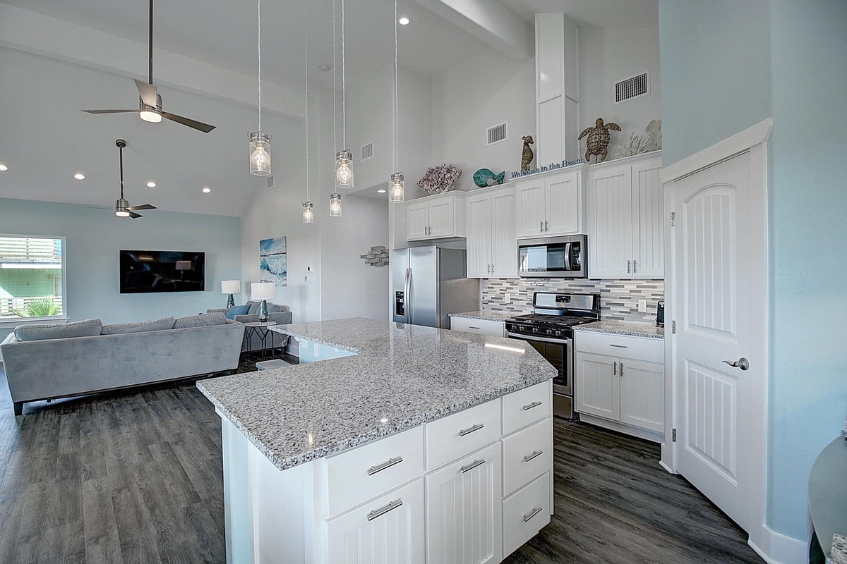 Your modern kitchen awaits with granite counters, stylish pendant lighting, and everything you need to create memorable meals together.