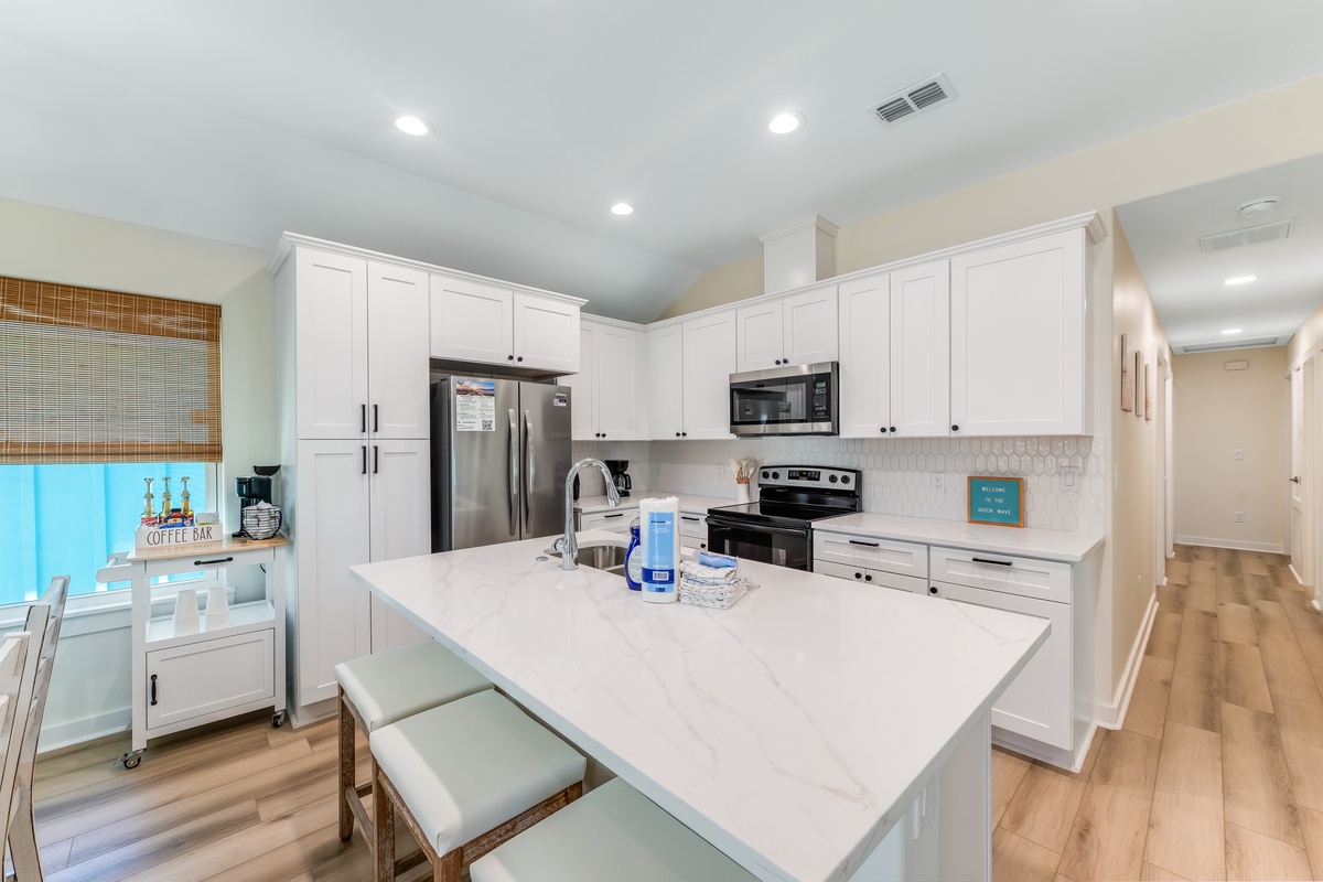 Your fully-equipped kitchen awaits with spacious counters, stainless appliances, and a breakfast island where you'll start each morning perfectly.