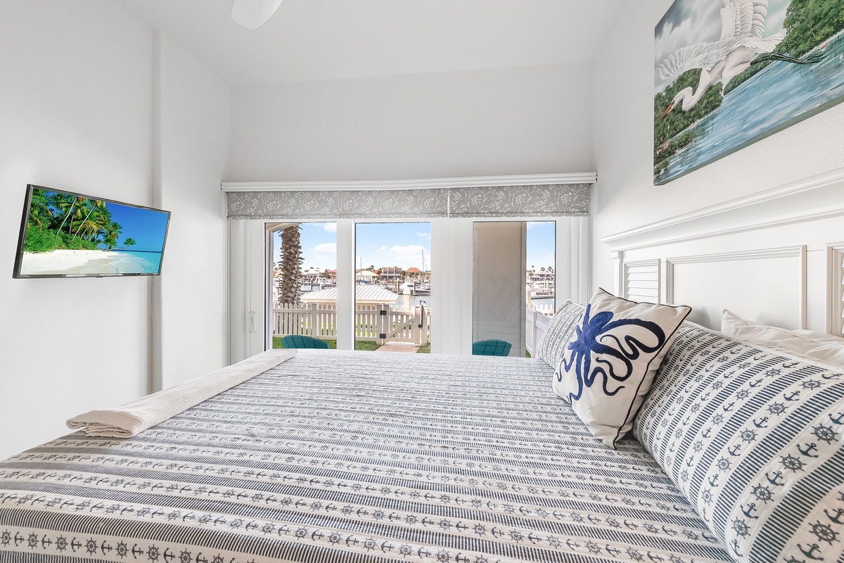 Wake up to stunning marina views from your comfortable bed, where nautical decor meets modern comfort in this bright, airy retreat.