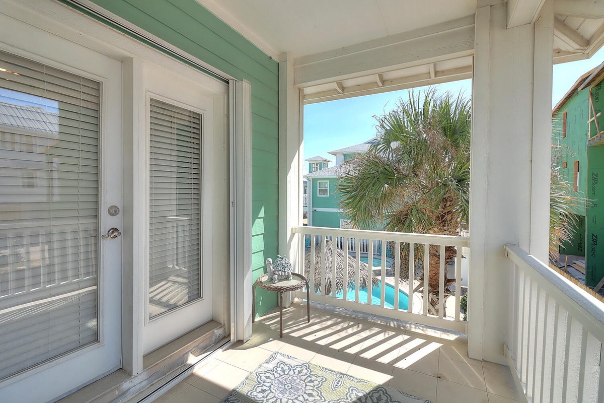 Step onto your private balcony where morning coffee tastes better with tropical palm views and colorful coastal charm.