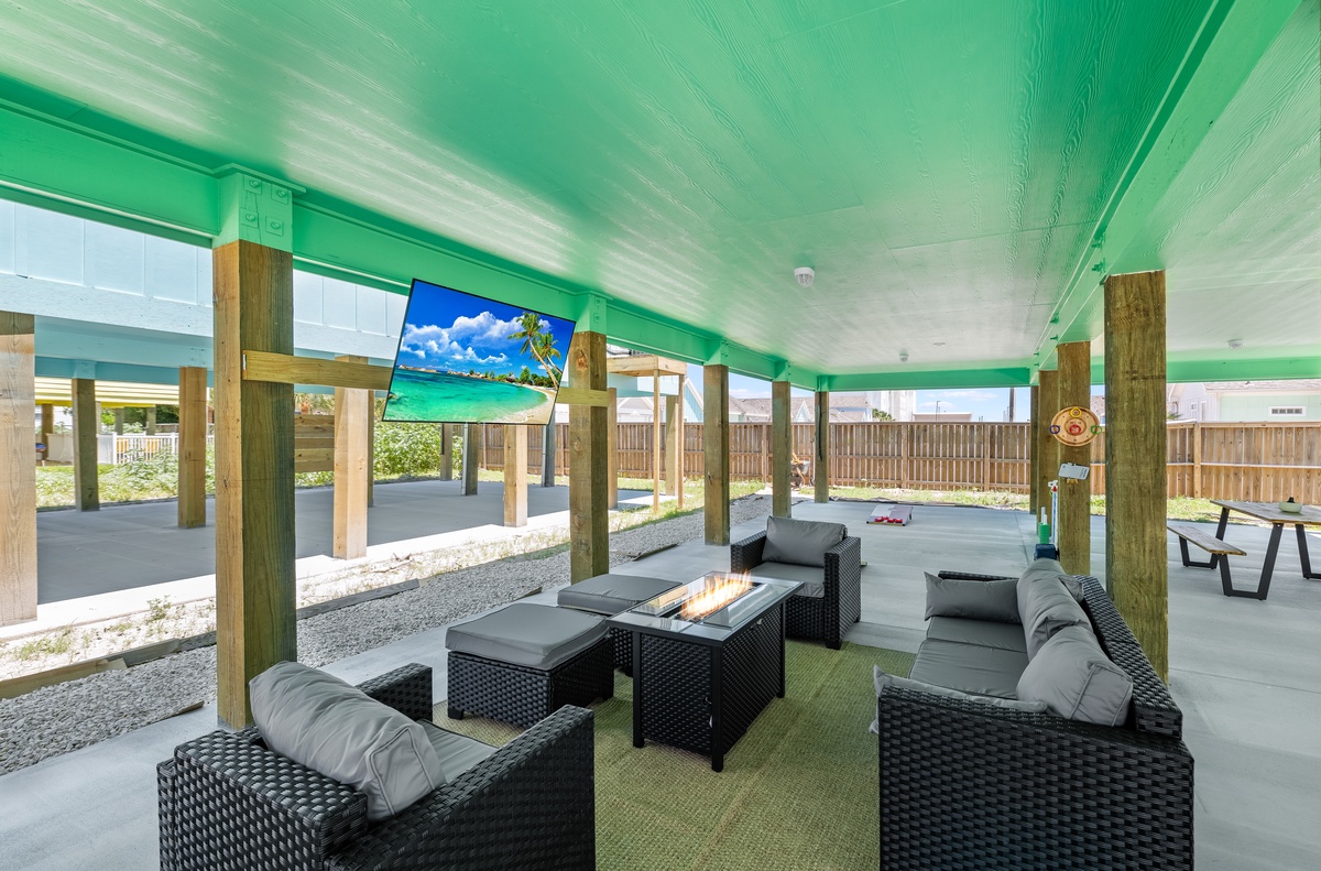 Relax under your private pavilion with plush seating and a crackling fire table while watching tropical scenes on the outdoor TV.