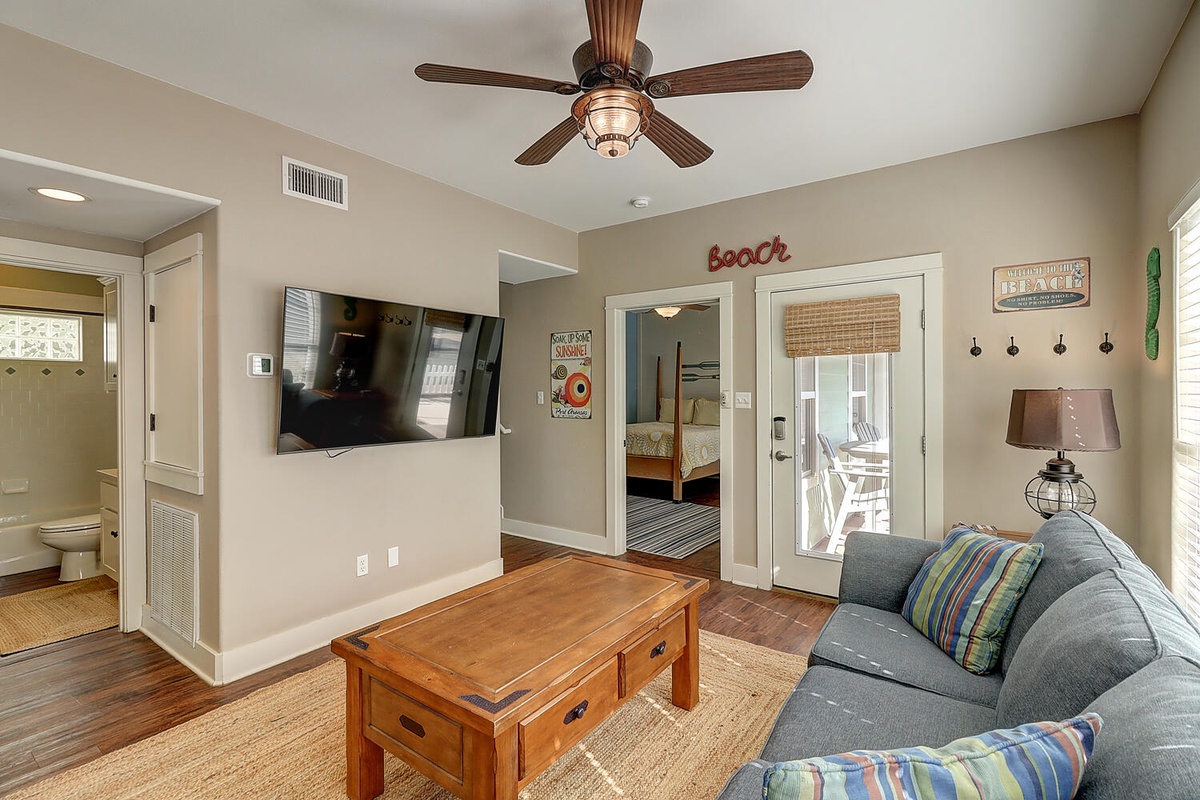 Relax in your coastal living space with comfy seating and beach-themed décor, plus a flat-screen TV for entertainment.