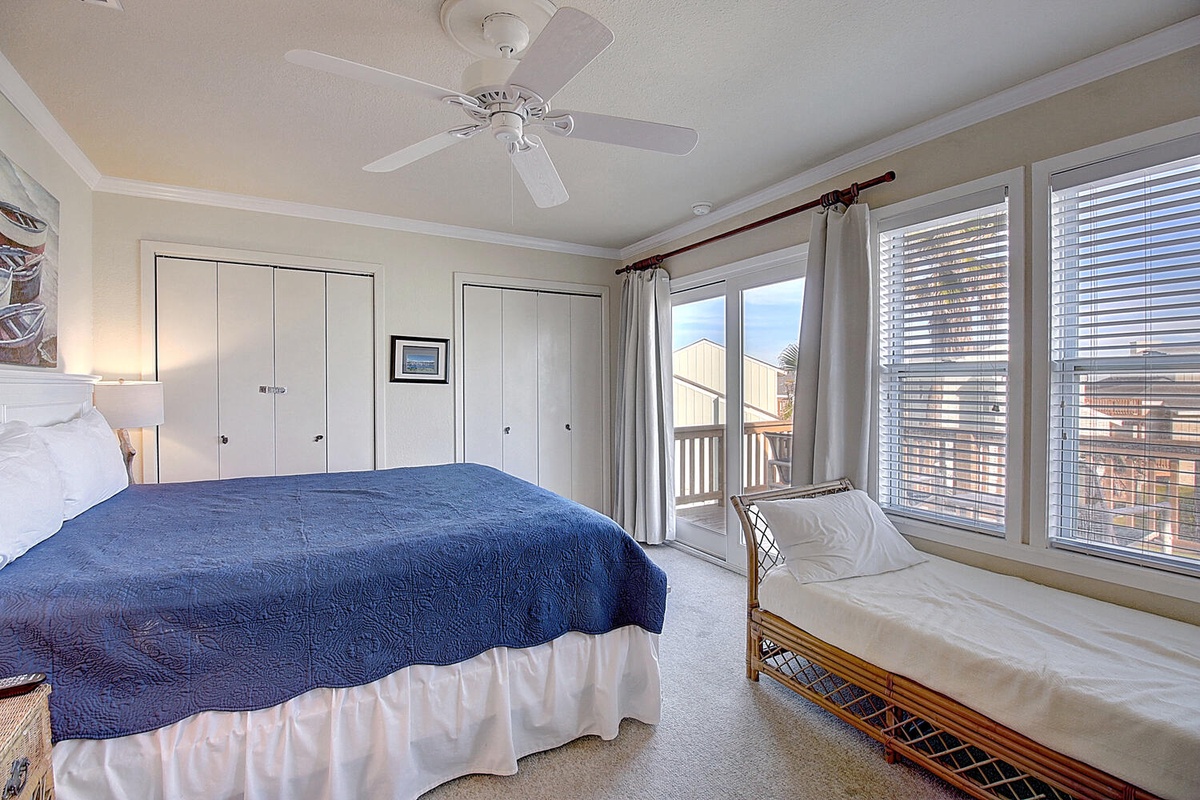 Rest peacefully in your bright bedroom with a balcony door opening to ocean views and extra seating for morning coffee.