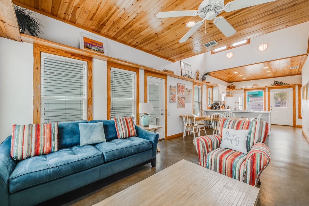 Relax in your bright coastal retreat with soaring wood ceilings, comfy seating, and an open kitchen perfect for beach getaway memories.