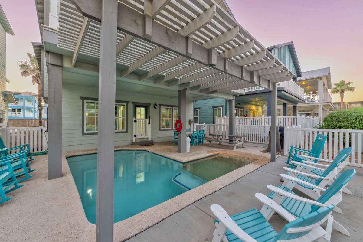 Dive into your private pool paradise with colorful beach chairs and a stylish pergola creating perfect poolside shade.