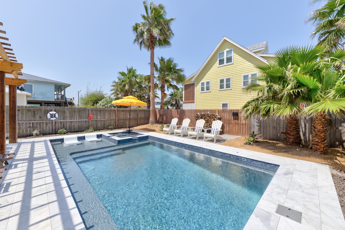 Dive into your private oasis where sparkling waters invite relaxation under swaying palms and endless blue skies.