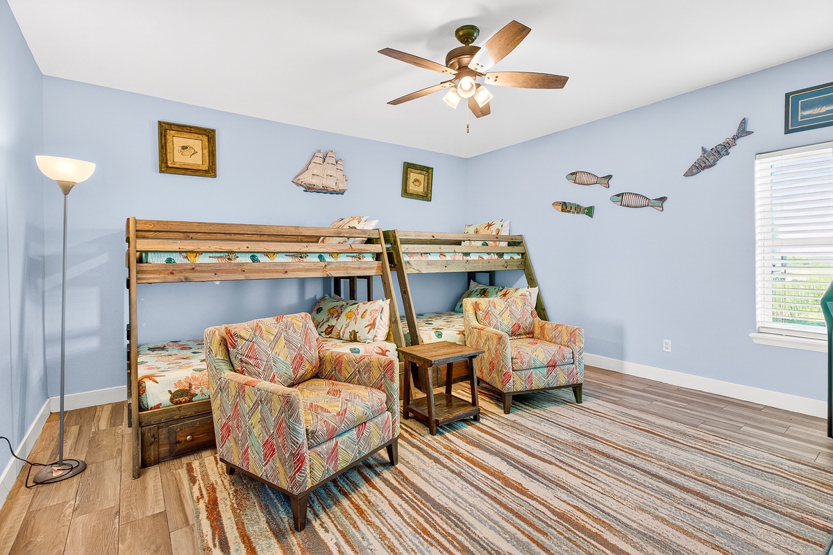 Your kids will love this nautical-themed room with cozy bunk beds and playful ocean decor creating the perfect bedtime adventure.