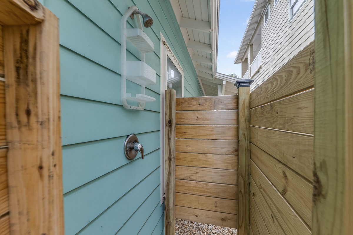 Rinse off the day in your private outdoor shower, surrounded by coastal charm and warm wood accents.