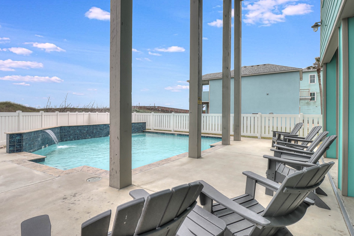Relax in your private poolside paradise with comfortable loungers and stunning turquoise waters, all under beautiful blue skies.