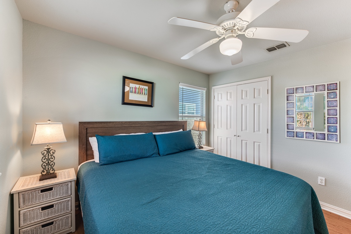 Your peaceful bedroom retreat features a plush king bed with crisp linens and gentle ceiling fan breezes for perfect comfort.