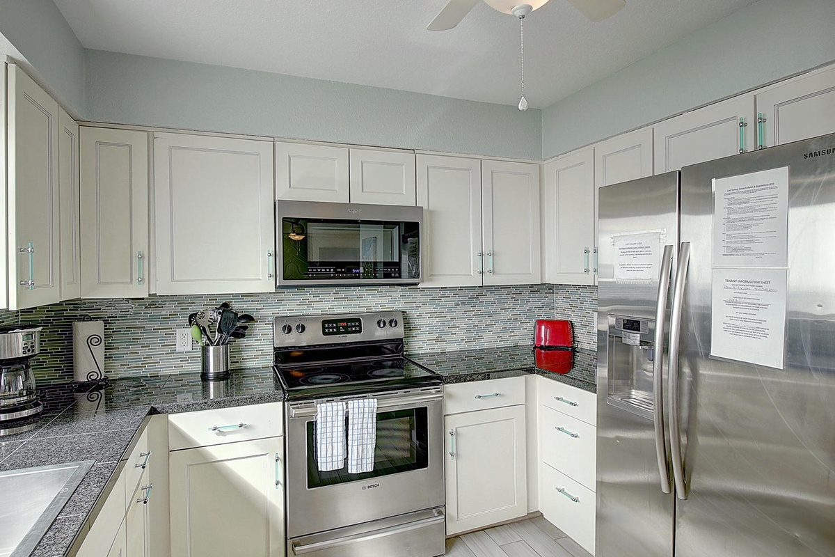 Your fully equipped kitchen features granite counters, stainless appliances, and stylish mosaic backsplash for memorable meal prep.