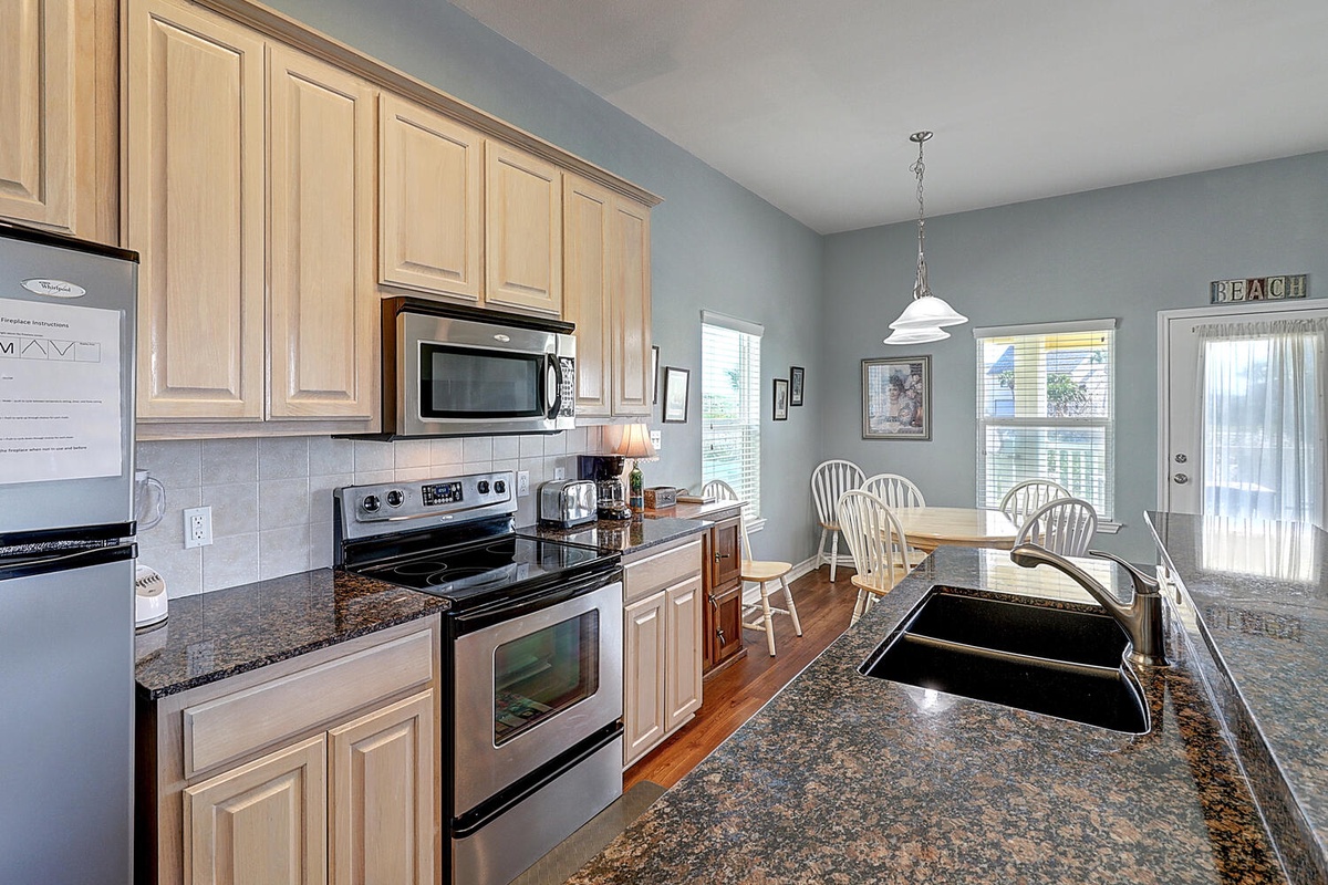 Your fully equipped kitchen features granite counters, stainless appliances, and a sunny dining nook perfect for morning coffee.
