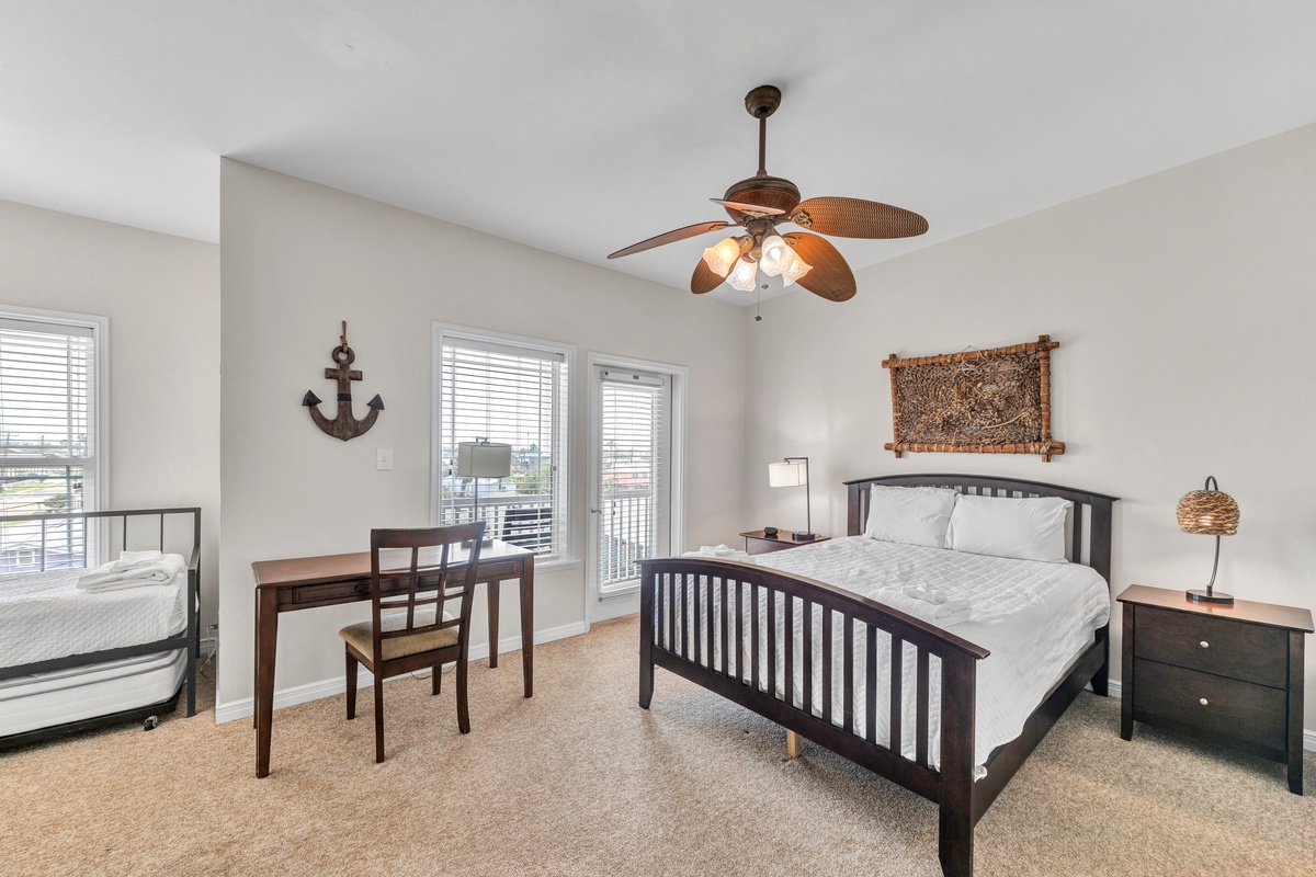 Sleep peacefully in your coastal-themed bedroom with comfortable furnishings, nautical touches, and natural light streaming through the windows.