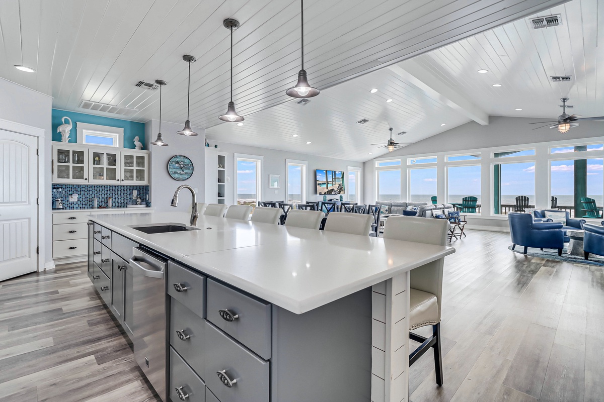 Your spacious coastal kitchen flows seamlessly into the living area, where panoramic windows frame breathtaking ocean views for your daily inspiration.