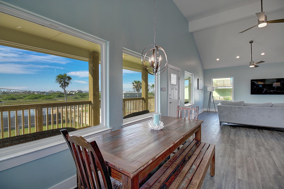 Gather around the handsome dining table where ocean breezes flow through open windows, creating the perfect spot for memorable meals.