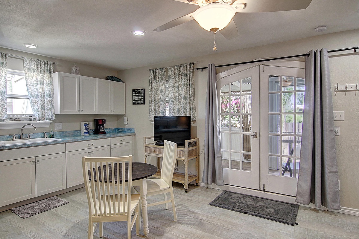 Your bright kitchen-dining area features modern appliances and French doors opening to your private outdoor space.