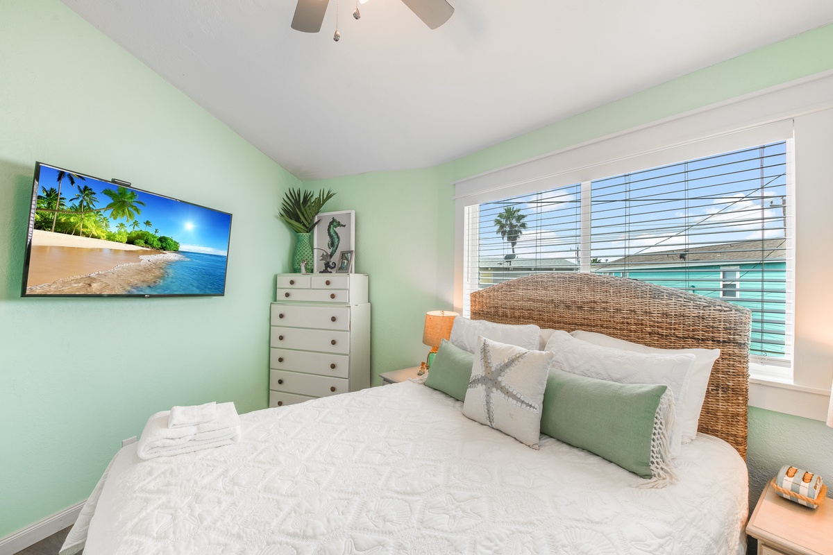 Wake up in your coastal-inspired bedroom with soft mint walls, tropical views on the big screen TV, and glimpses of paradise through your window.