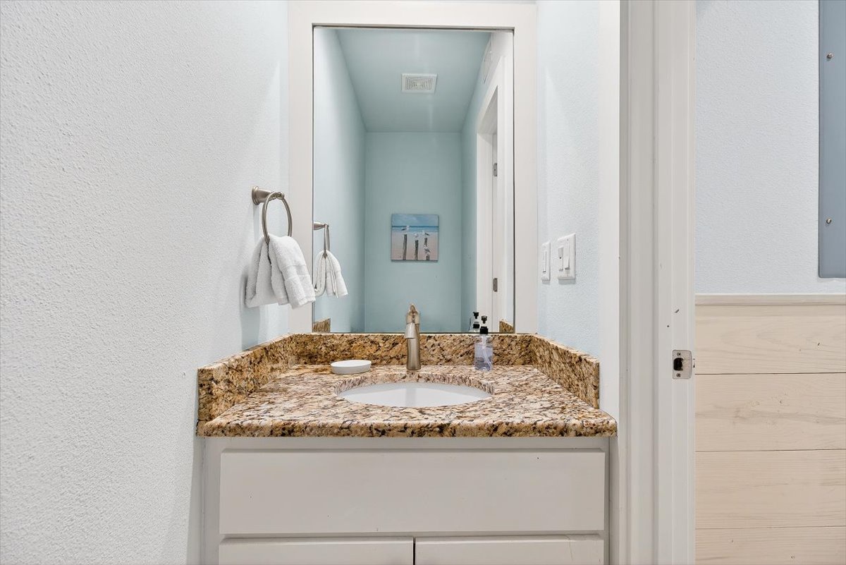 You'll love this elegant bathroom vanity with granite countertops and fresh linens, perfect for your morning routine.