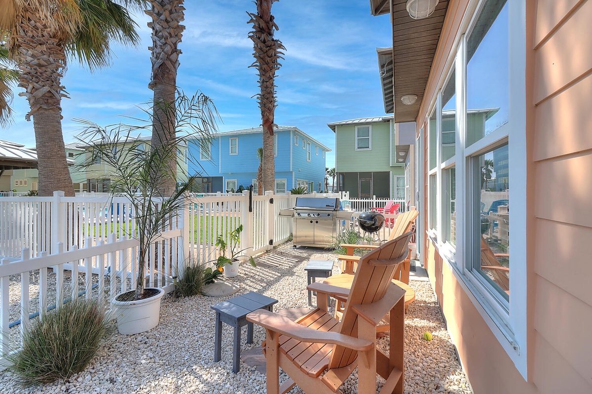 Your private patio beckons with comfortable seating and tropical palms, perfect for morning coffee or evening relaxation.